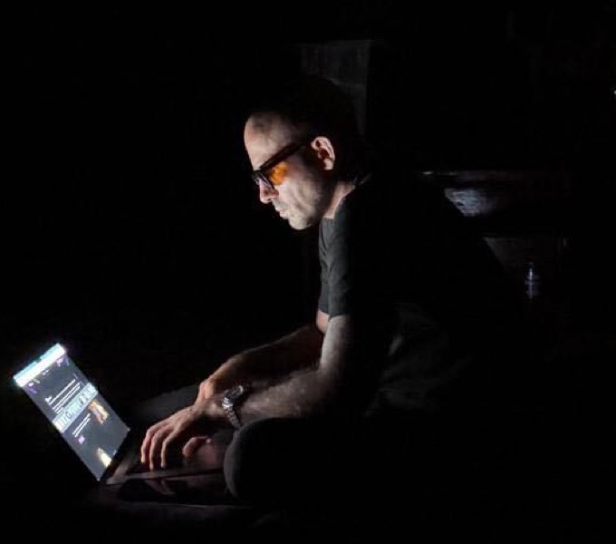 Jonathan Matthey working on a laptop in the dark